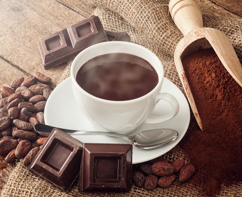Imagen de chocolate a la taza con onzas de chocolate al lado.